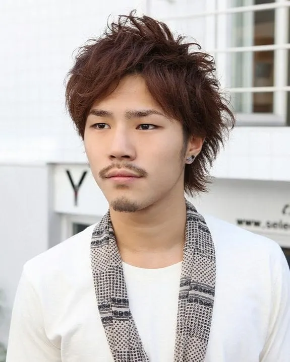 Mens long tousled hairstyle featuring an asian man in a scarf