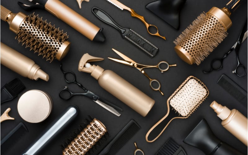 As an image for a piece on Hair Cuttery Prices, Full frame of professional hair dresser tools on black background