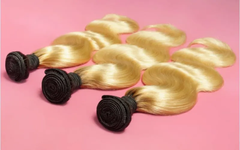 Body wave wavy black to blonde two tones ombré style human hair weaves extensions bundles as an image for a piece on hair extensions cost