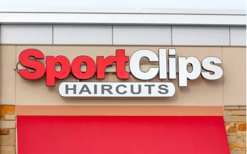 As a featured image for a piece on Sport Clips Prices, SportClips exterior and logo. Sport Clips is an American-based chain of haircut salons
