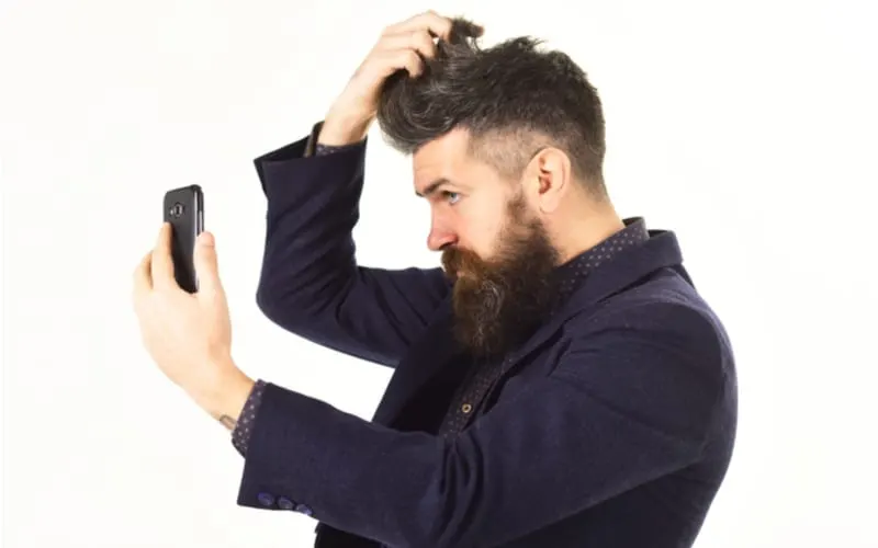 Short sides long top Stylish haircut concept. Bearded man with fashionable hair cut. Male fashion.