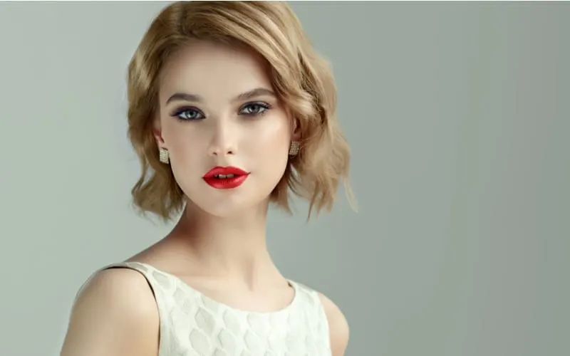 Beautiful model girl with short curly hair and red lips