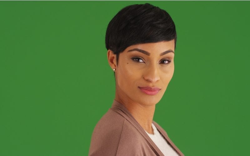 Confident African American female looking at camera on green screen