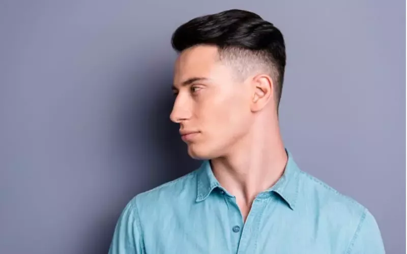 Profile side view of nice cute attractive handsome cool confident content man wearing blue formal shirt good haircut isolated over pastel grey violet background