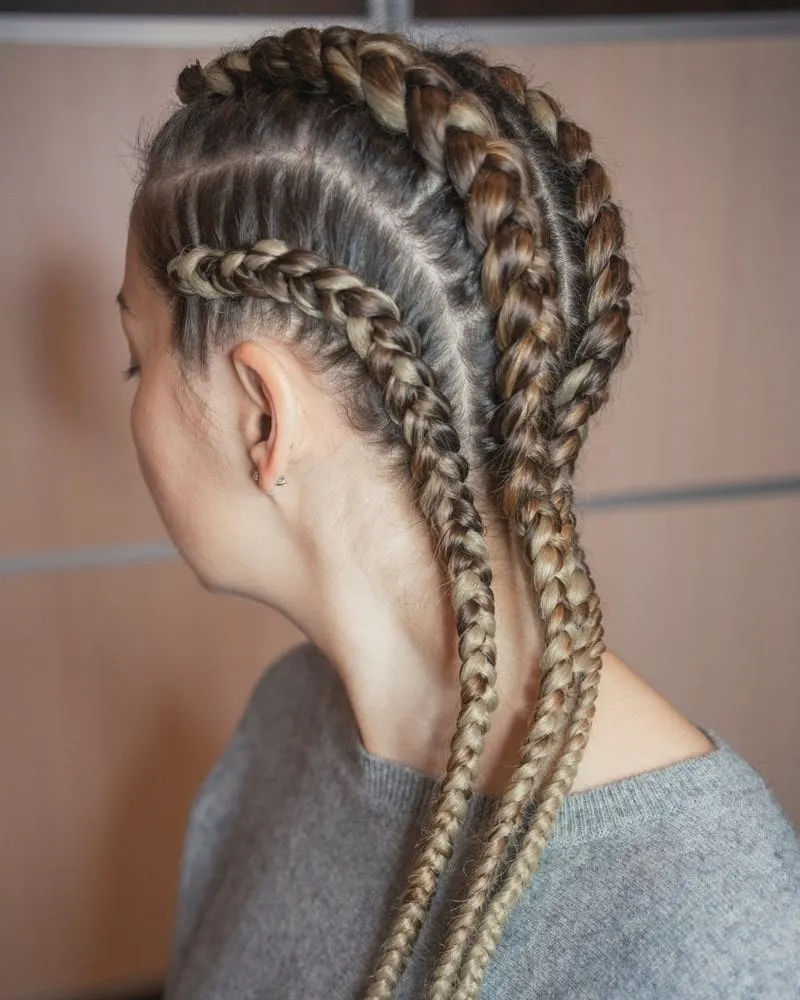 Tight cornrows on a woman looking to the right
