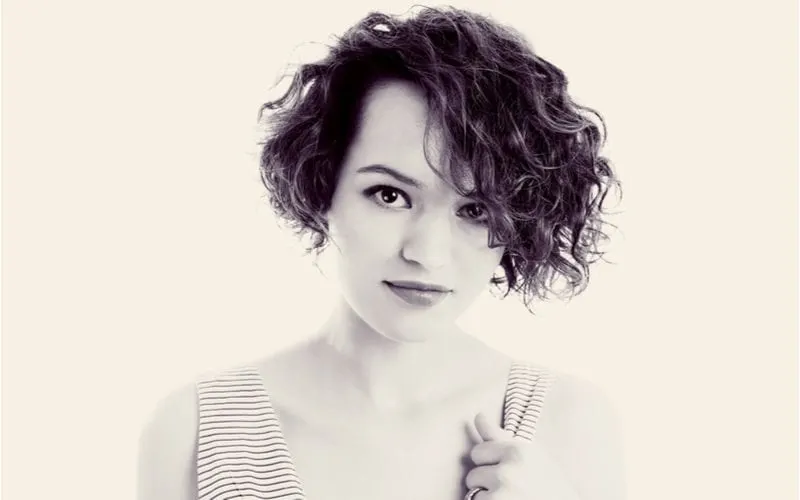 Portrait of a smiling beautiful woman with curly hair, old B & W photo.