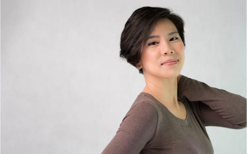 Portrait of an attractive asian middle aged short hair style woman in her 40s smiling looking at the camera feeling cheerful, Satisfied and Confident. Middle aged Beauty and Healthy aging concept.