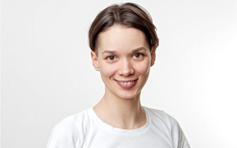 Woman with a two block haircut looking at the camera