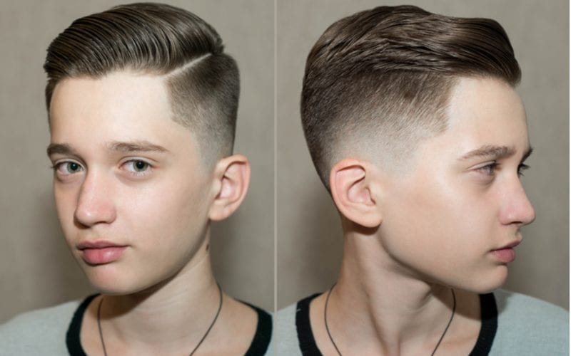 Stylish modern retro haircut side part with mid fade with parting of school boy guy in a barbershop on a brown background for a piece on what is a fade haircut
