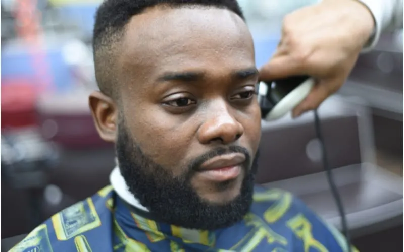 Black man in a barber shop with a high fade crop haircut