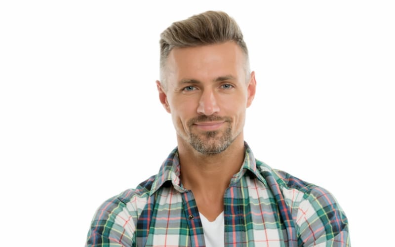 Looking handsome. Handsome middle-aged man isolated on white. Handsome look of unshaven adult with a high fade haircut