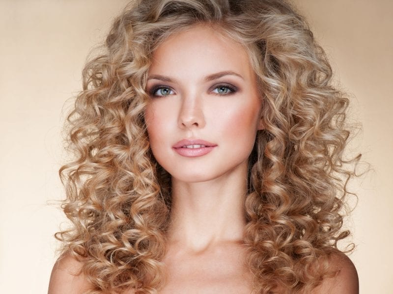 Beautiful blonde woman. Healthy Long Blond Hair. Curly Hair. Blond. Permed Hair. Afro curls. Beauty Model Girl with Luxurious Hair.