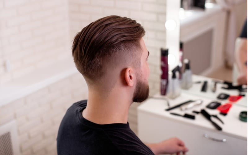 Male head with stylish haircut on barbershop background