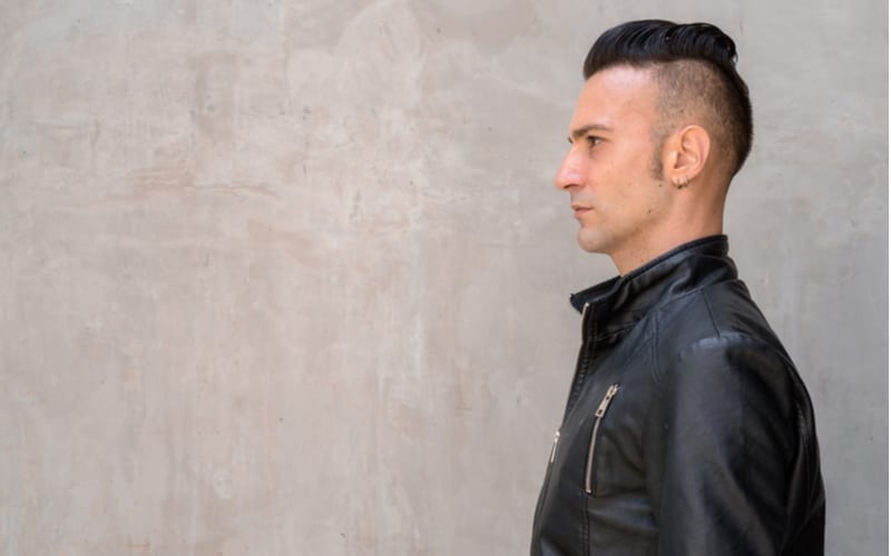 Profile view of handsome young Italian man with undercut wearing black leather jacket