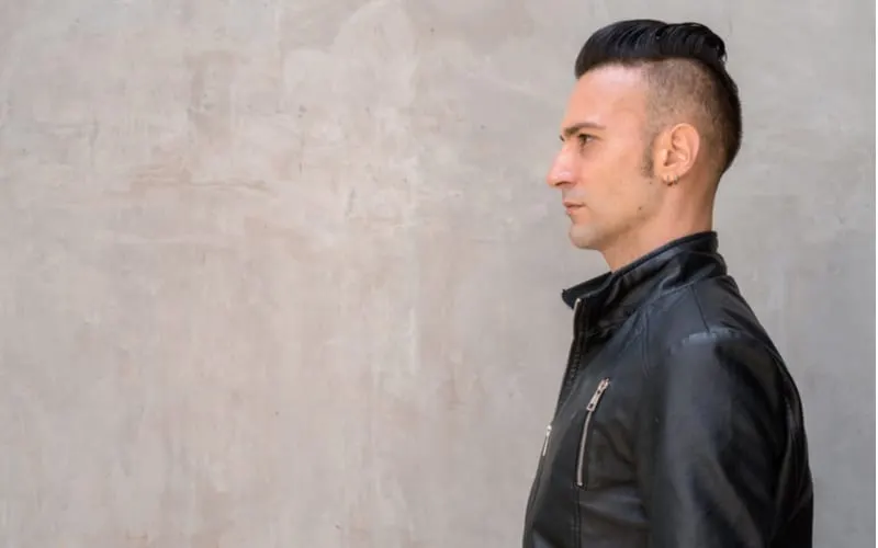 Profile view of handsome young Italian man with undercut wearing black leather jacket