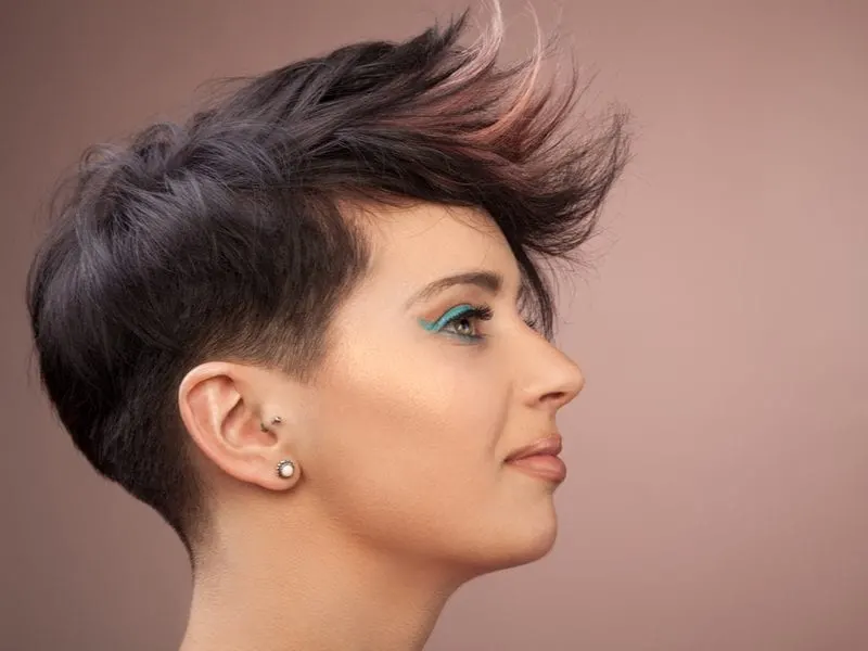 Woman with a trendy hairdo with a short mohawk