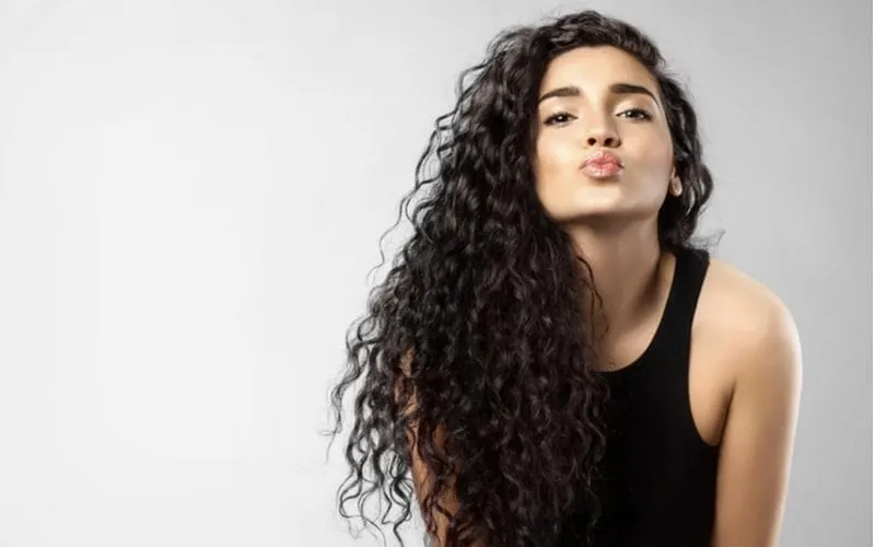 Real woman with beauty black hair gives a kiss