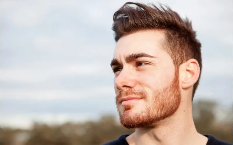 Guy with a nice haircut and a short beard looking to the right of the camera