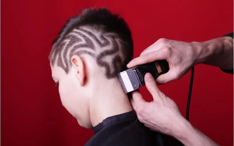 Cutting hair machine hairstyle hair tattoo as an example of an edgy undercut with trimmed sides