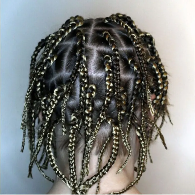 Person with short french braids and cornrows in a unique pattern