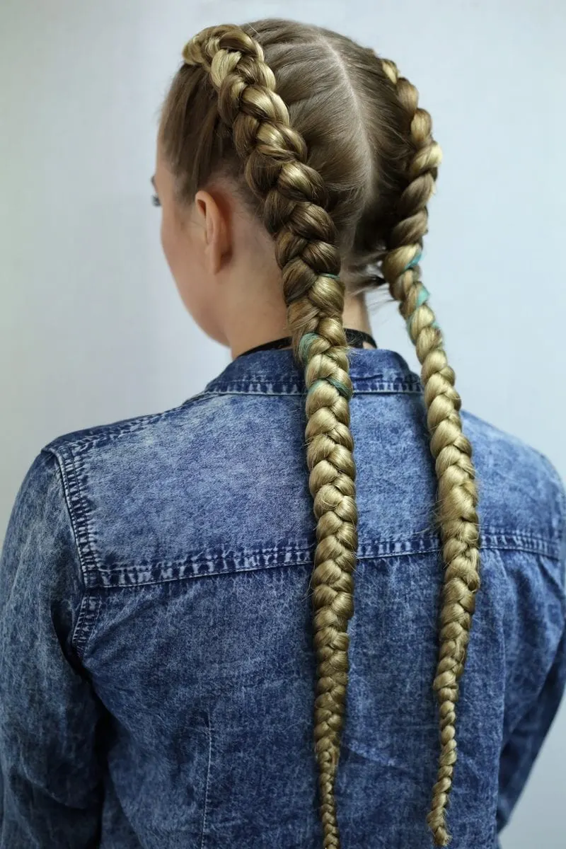 As an image for a piece on unprofessional hairstyles, braids on a woman in a blue jean jacket