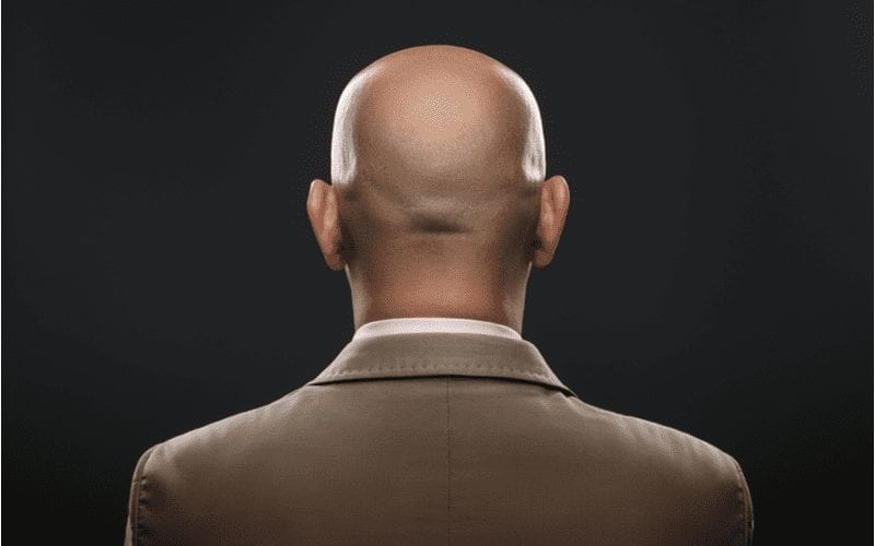 The back of a bald man in suit
