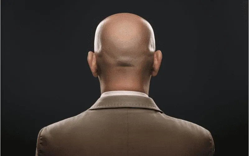 The back of a bald man in suit