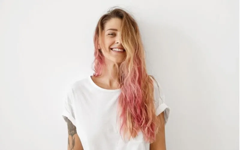 Woman has an unprofessional hairstyle of blonde with pink ends