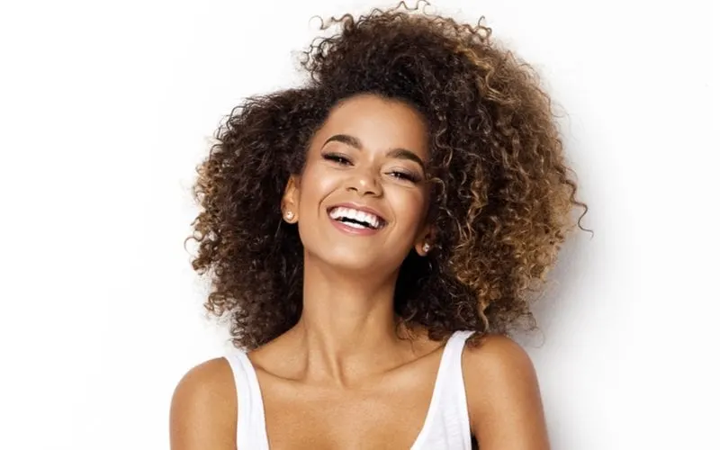 Beautiful african american girl with a curly haircut smiling