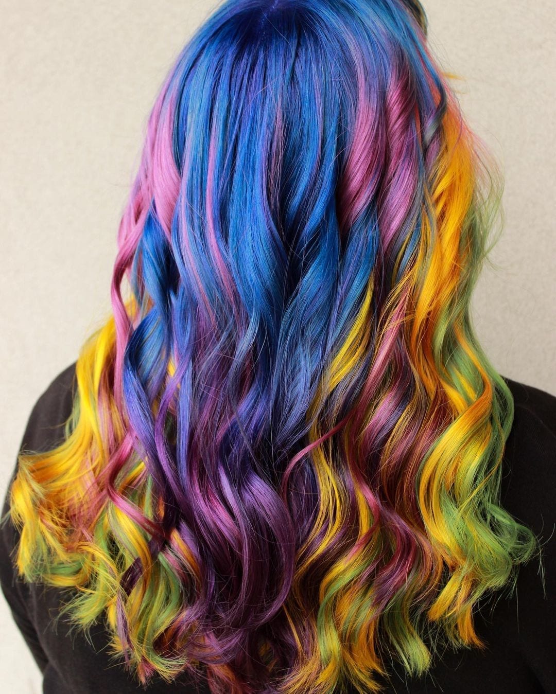 Girl with trix-inspired hair that looks like a rainbow and is very unprofessional looks away from the camera