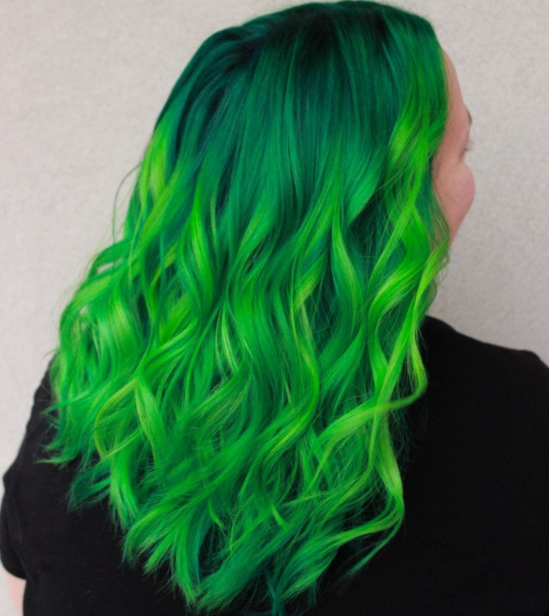 Green galaxy hair inspiration on a smiling woman in a black tshirt