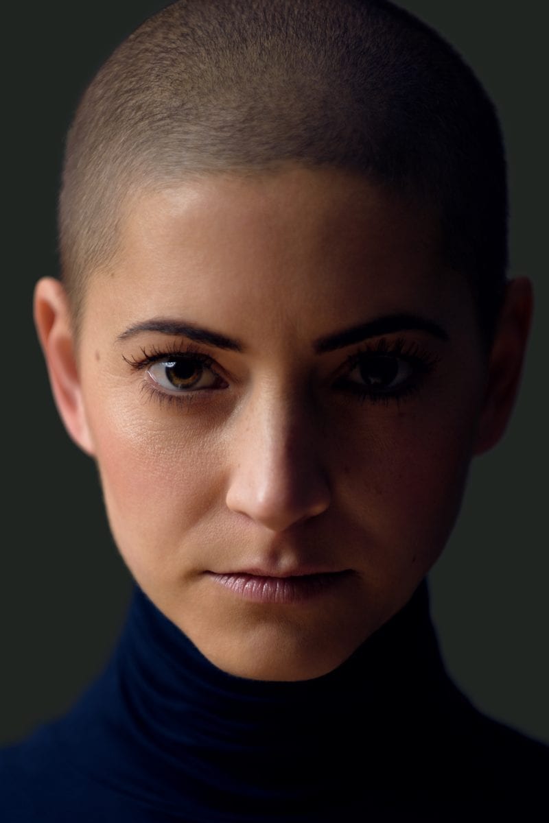 A shaved hairstyle for women featuring a number one buzz cut