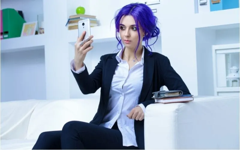 Woman with super bright, almost purple hair taking a selfie