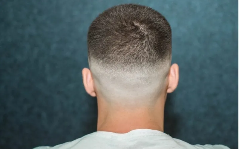 Sporty young man with a fade haircut shot with a camera from the back