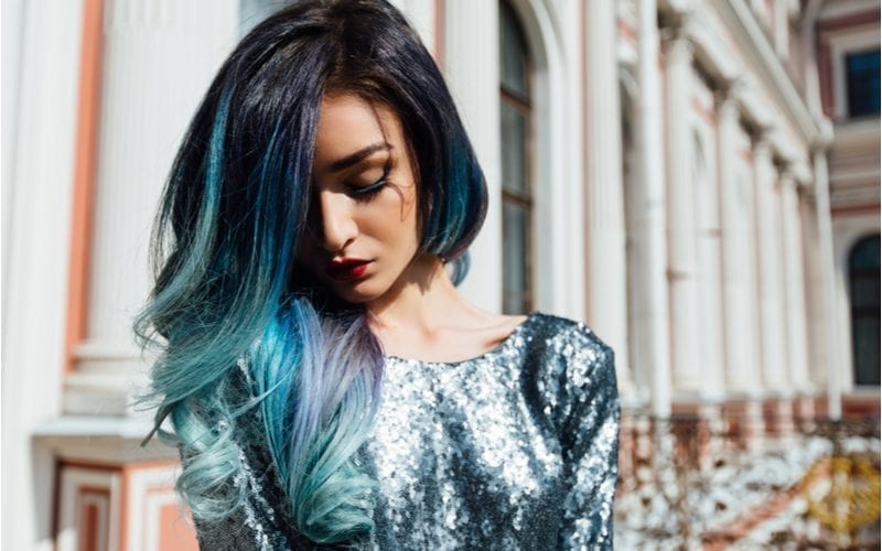 Woman with multi-colored teal hair wearing a teal sequin dress