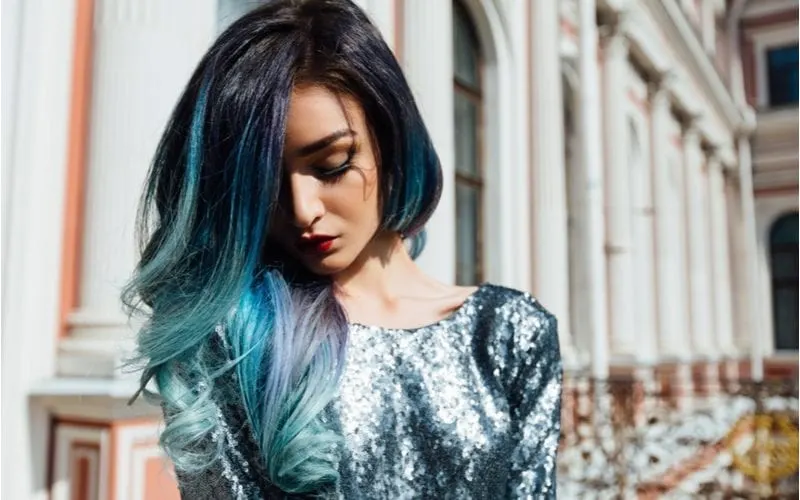 Woman with multi-colored teal hair wearing a teal sequin dress