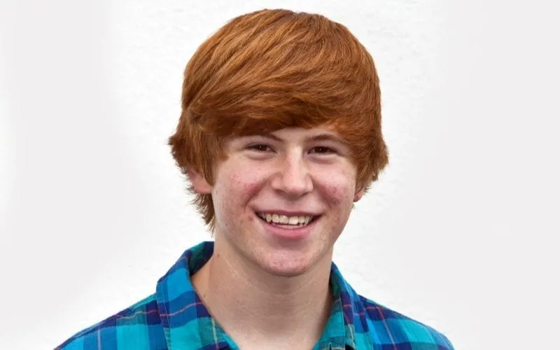 Smiling red headed man with a grin on his face