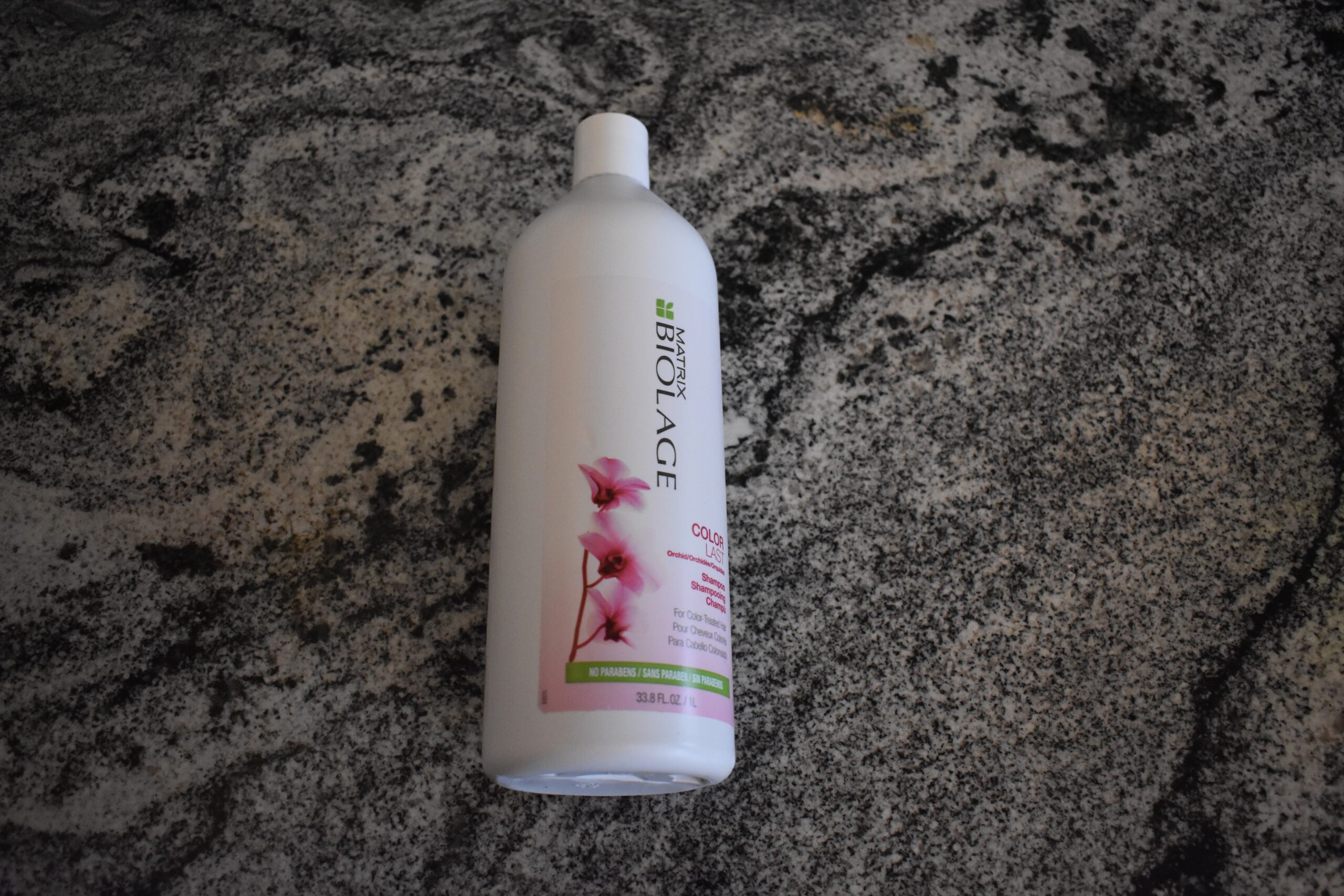 Bottle of Biolage colorlast shampoo sitting on a counter. it's one of the best shampoos you can buy.