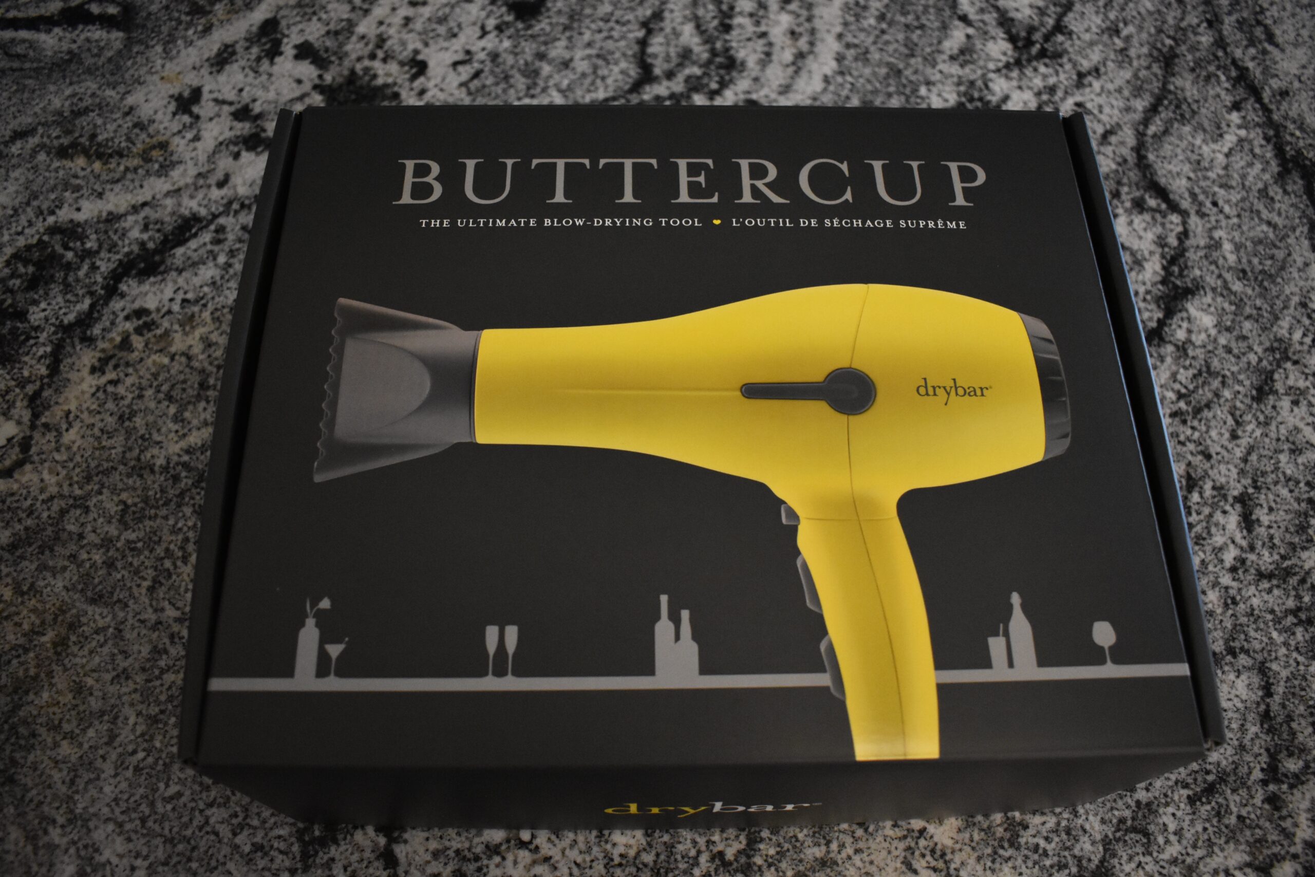 Image of the Drybar Buttercup (the best hair dryer) on the front of the black box