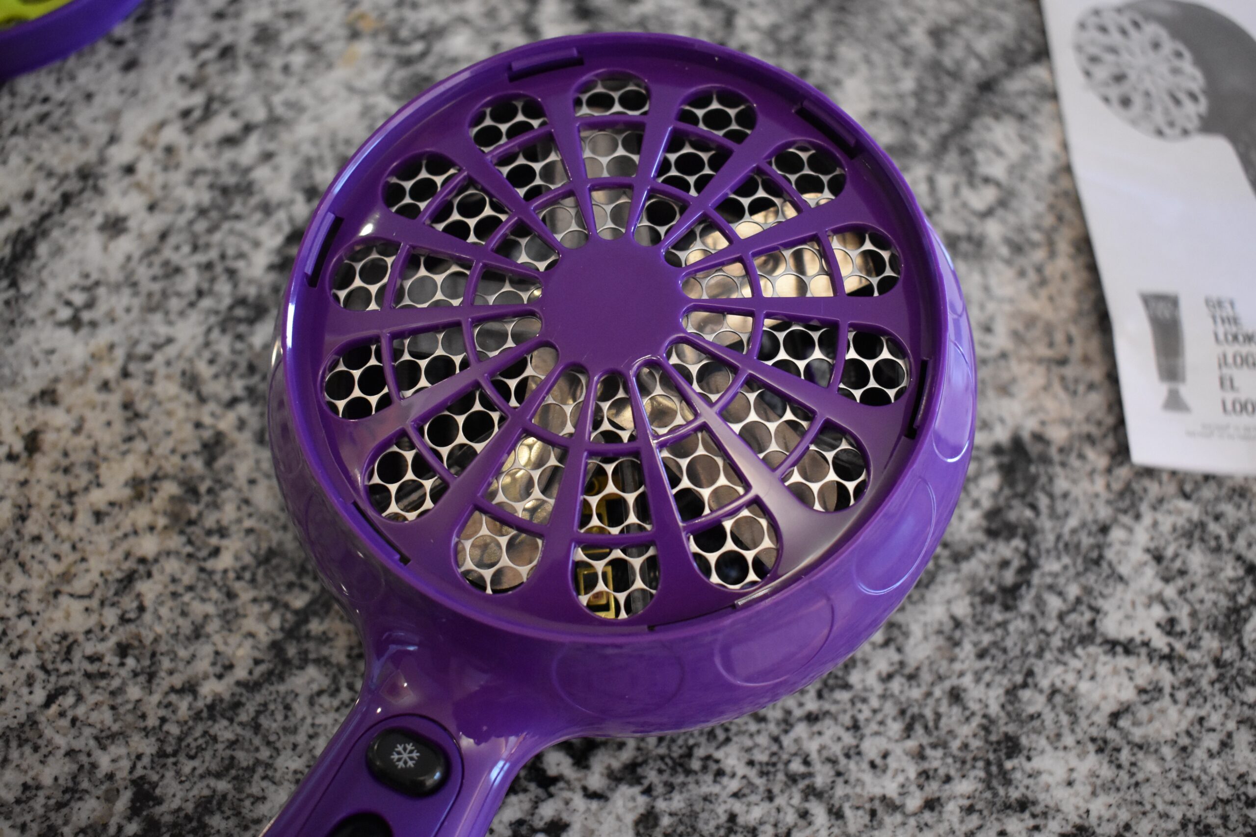 Close up up a purple hair diffuser, sans attachment