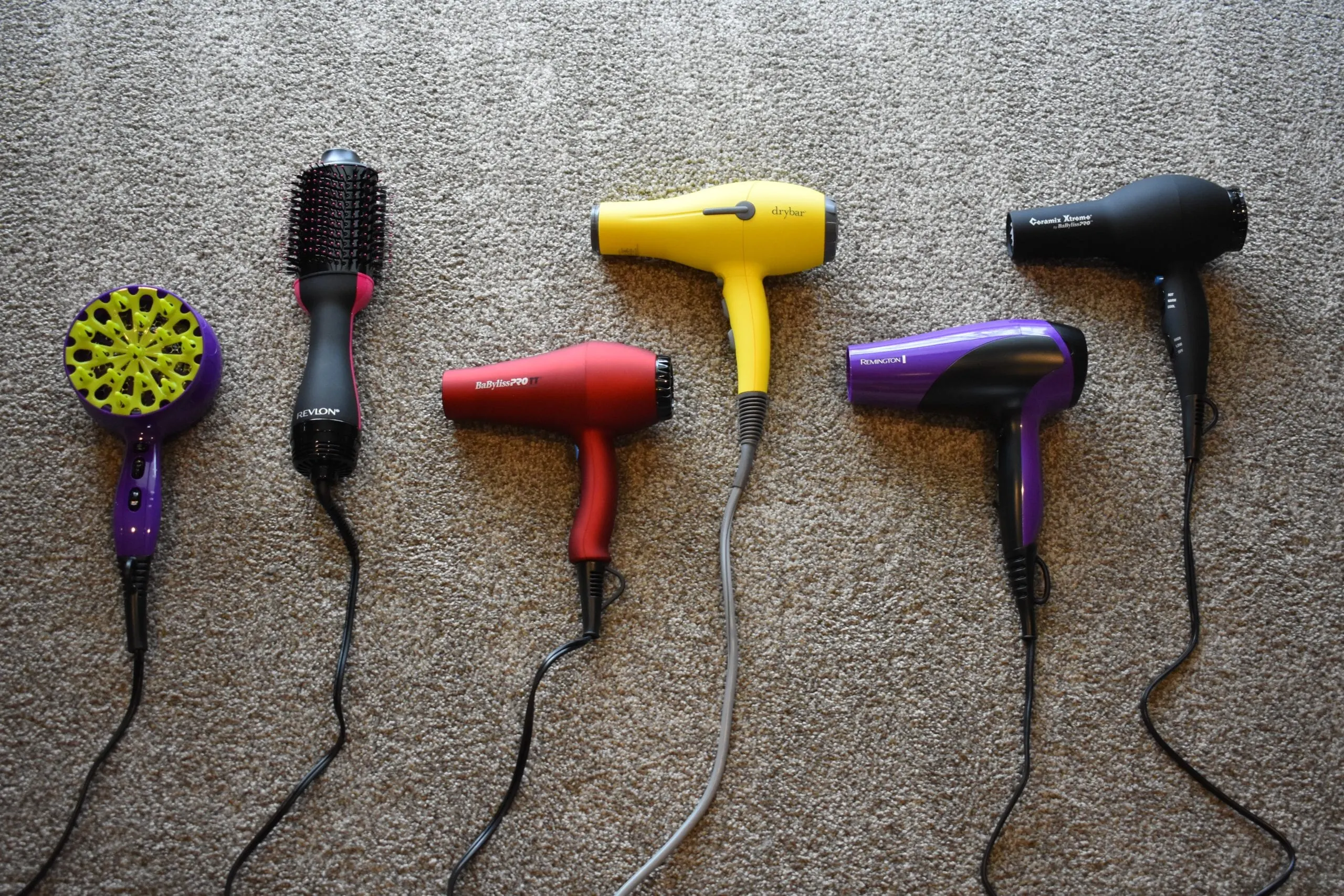 The best hair dryers on our list all sitting on a recently vacuumed carpet floor