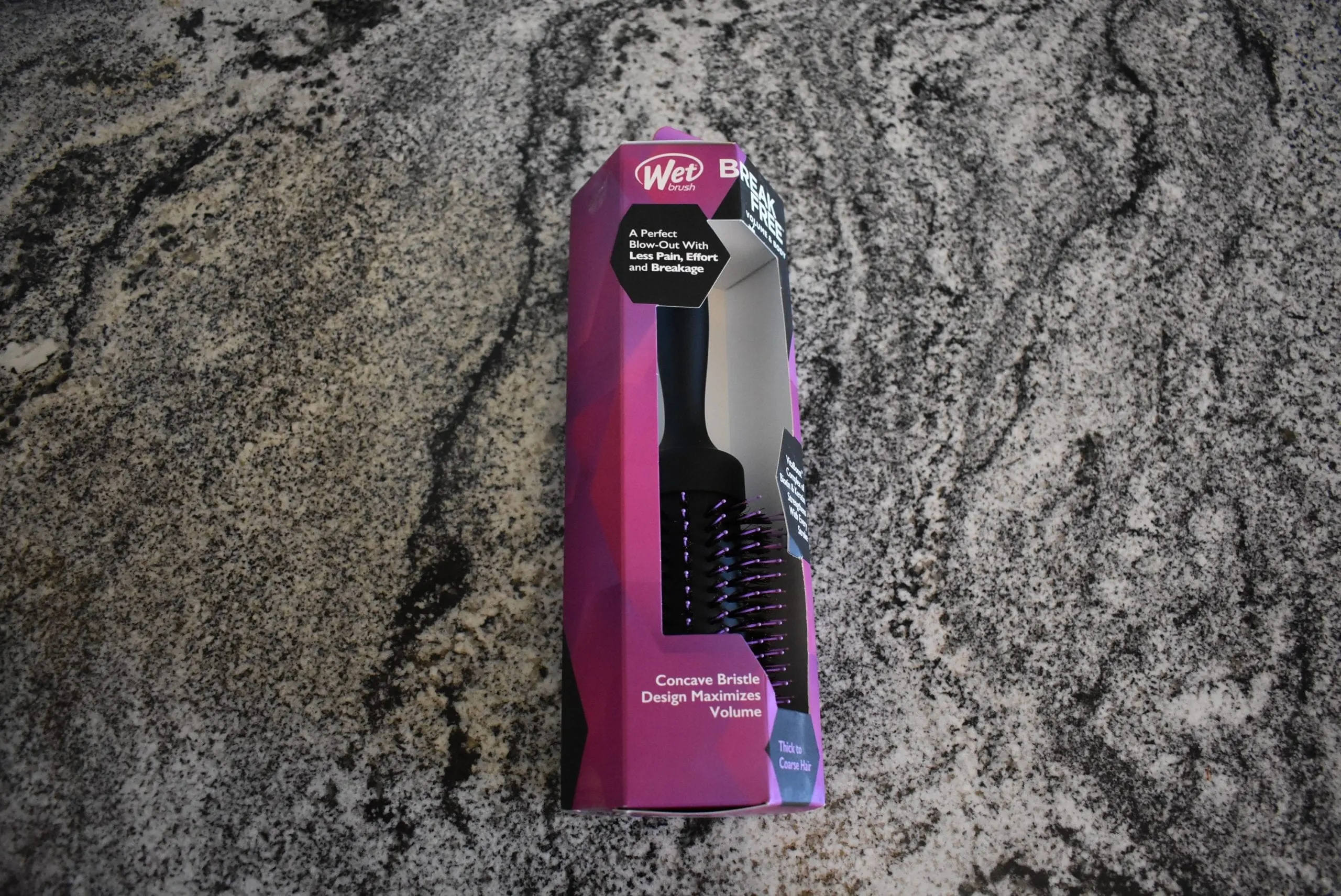 The Wet break hair brush inside its box on a grey granite counter for a review on the best hair brushes