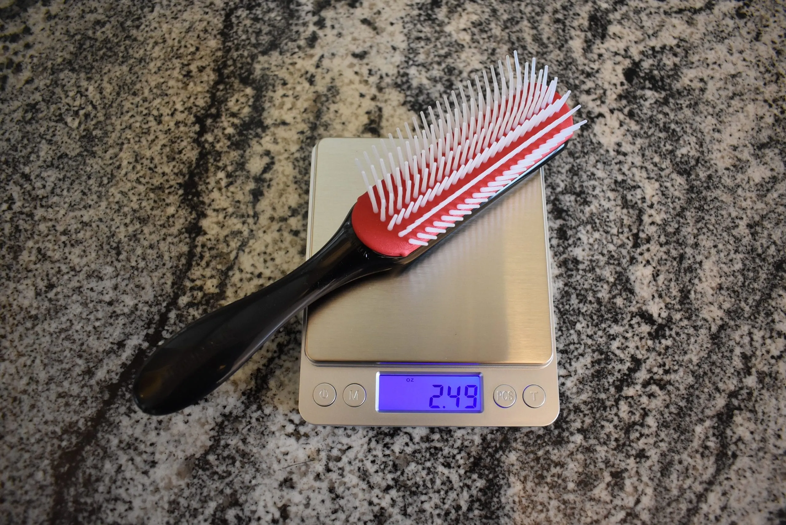 Denman D3 Original Styler Classic Styling Brush registering 2.49 oz on a scale