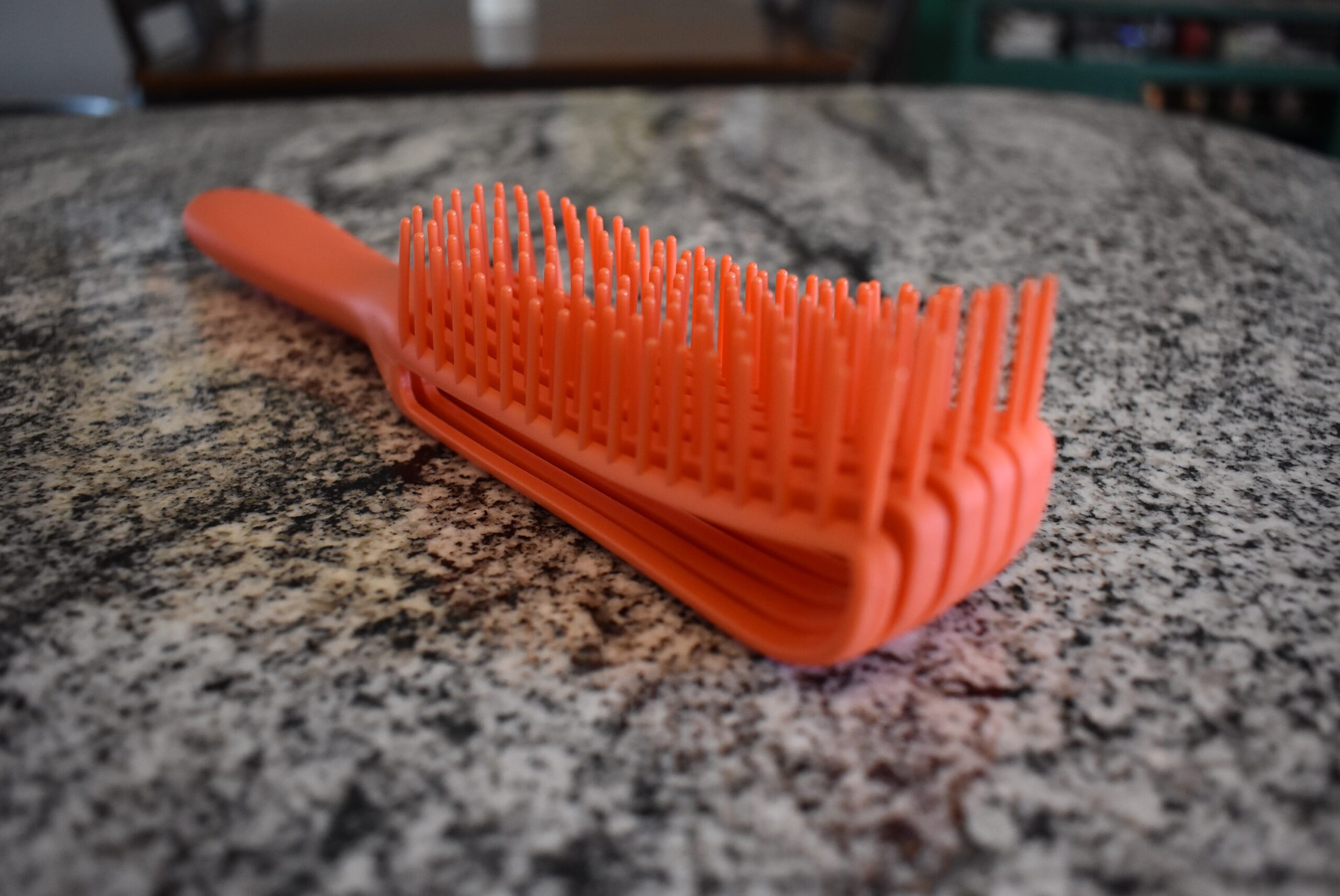 Close up of the best detangling brush in red