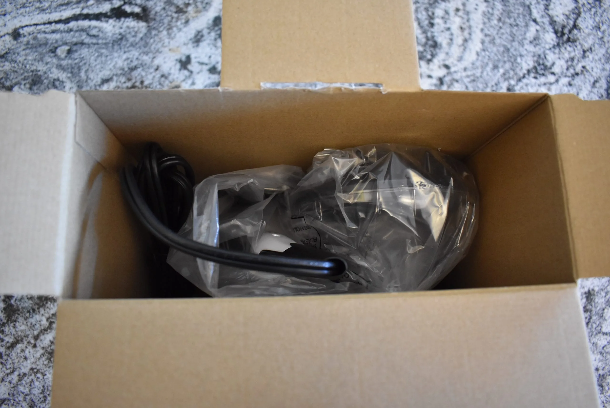 The Revlon 1875 watt hair dryer in its box and wrapped in plastic