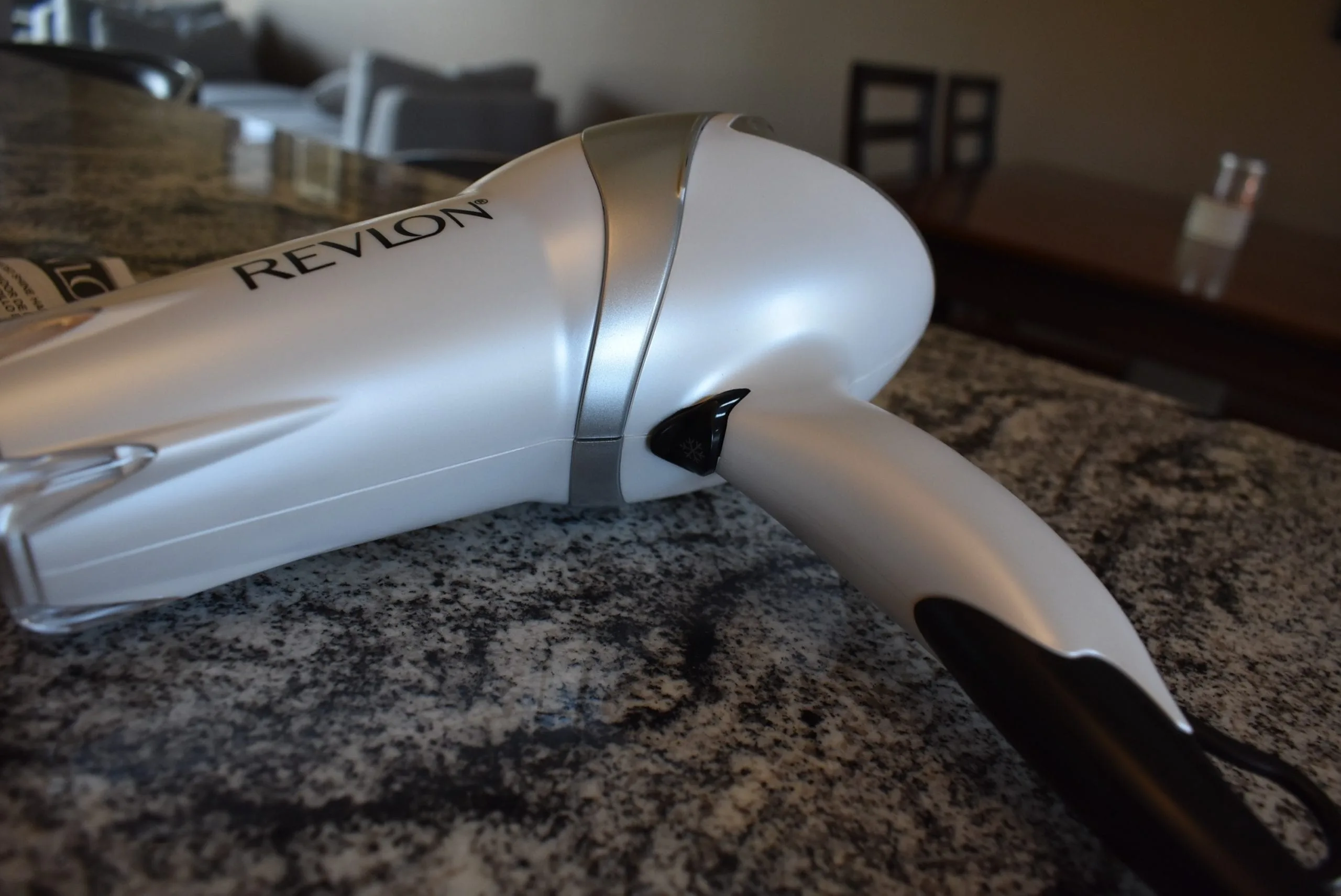The white Revlon hair dryer sitting on a counter
