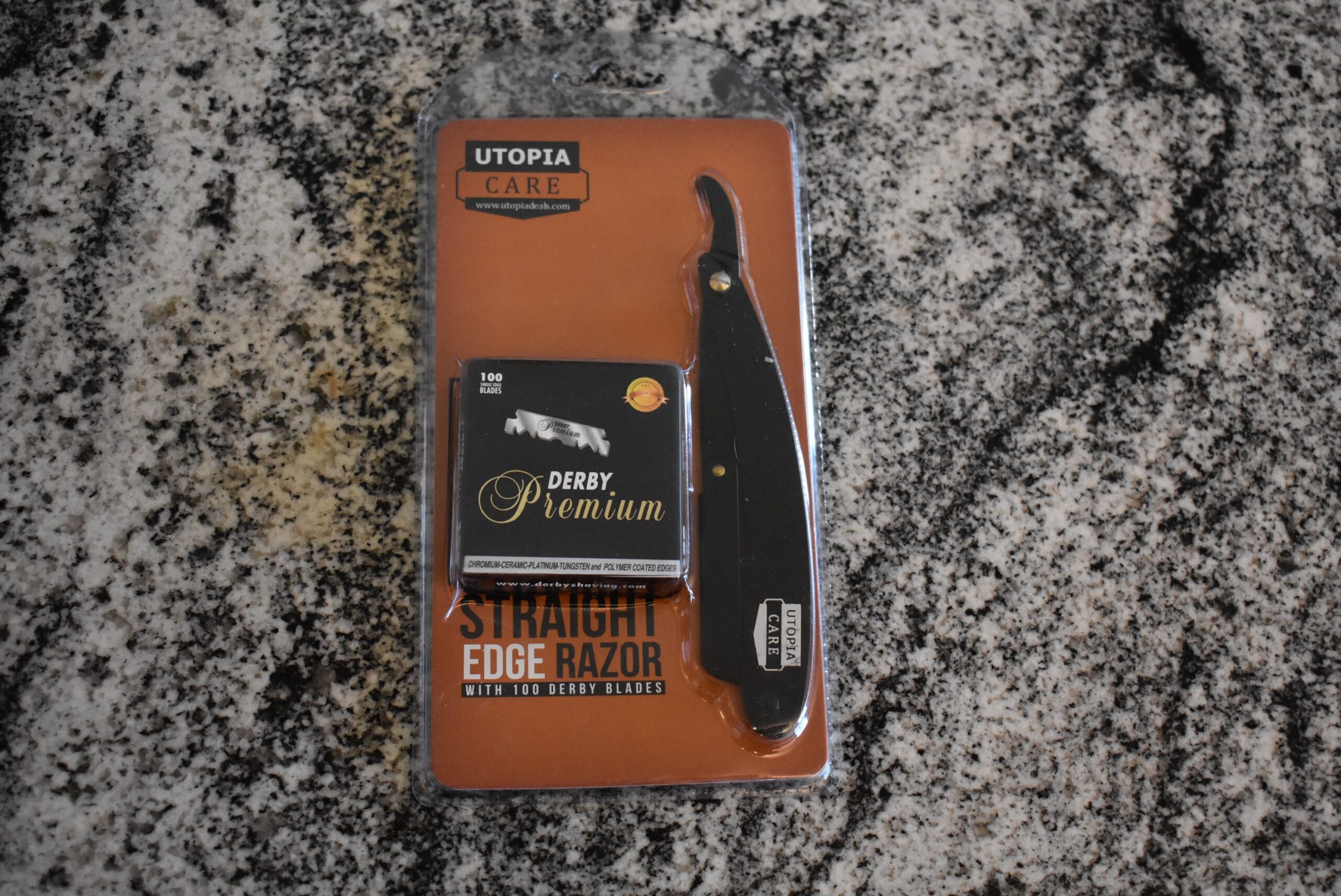 One of the best straight razors, the Utopia care straight razor in its package and on a counter