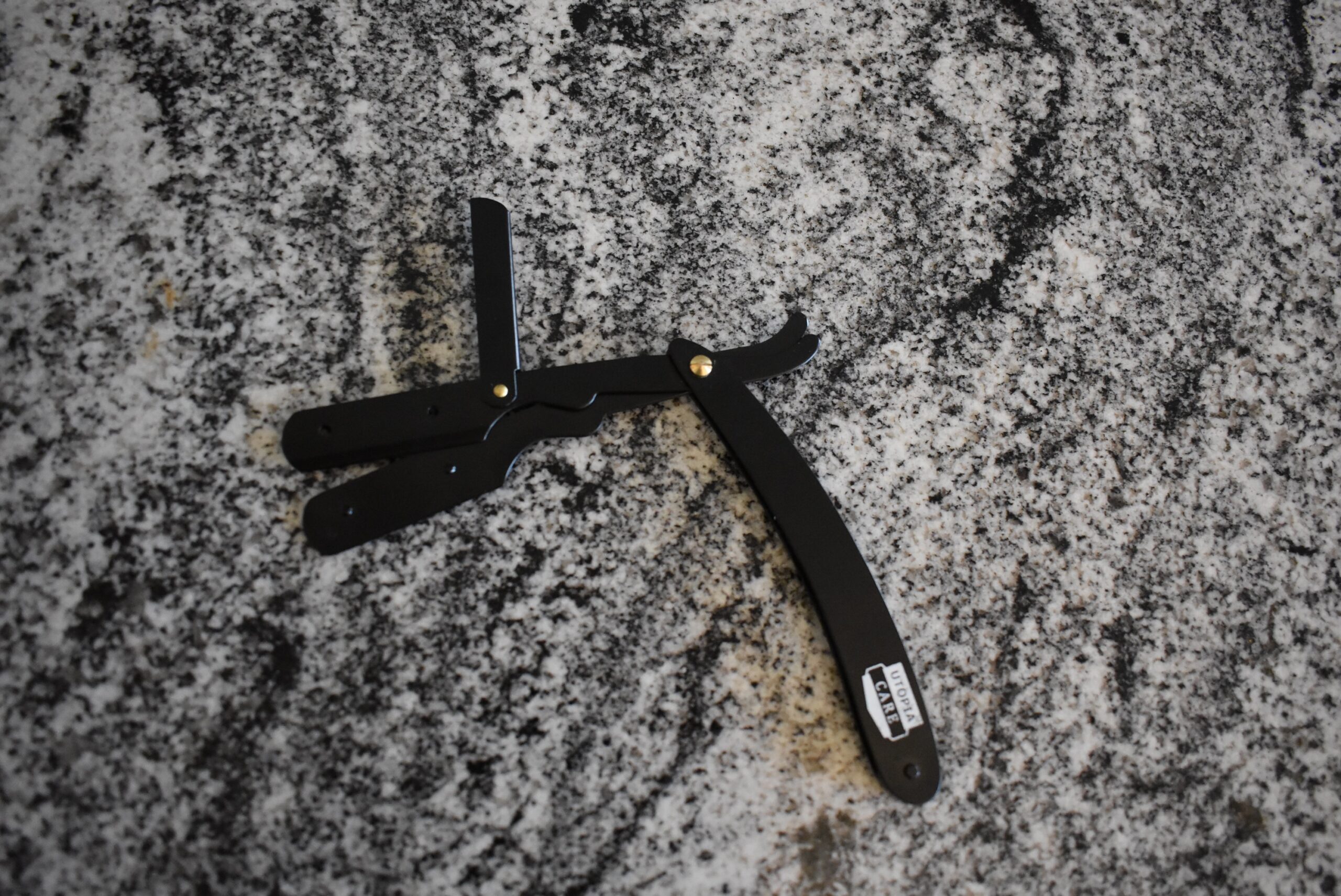 The Utopia care straight razor slightly open to allow a blade to be changed
