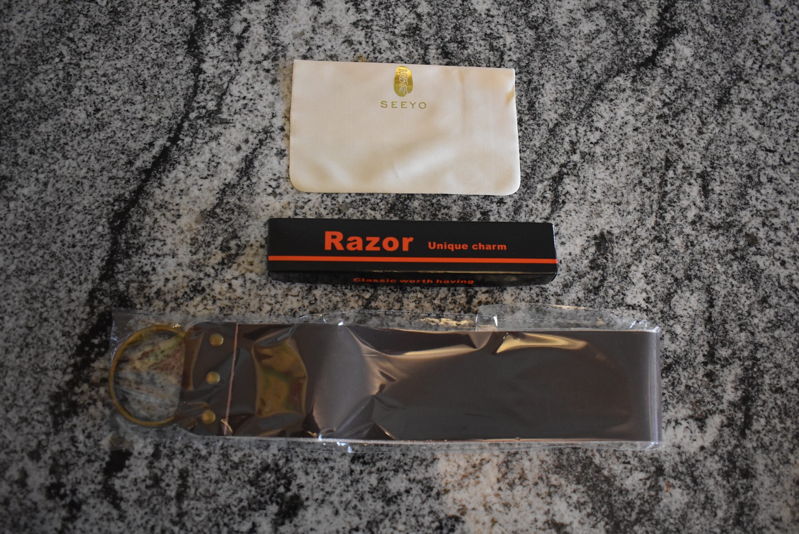 The Seeyo straight razor kit with all of the box contents on a counter