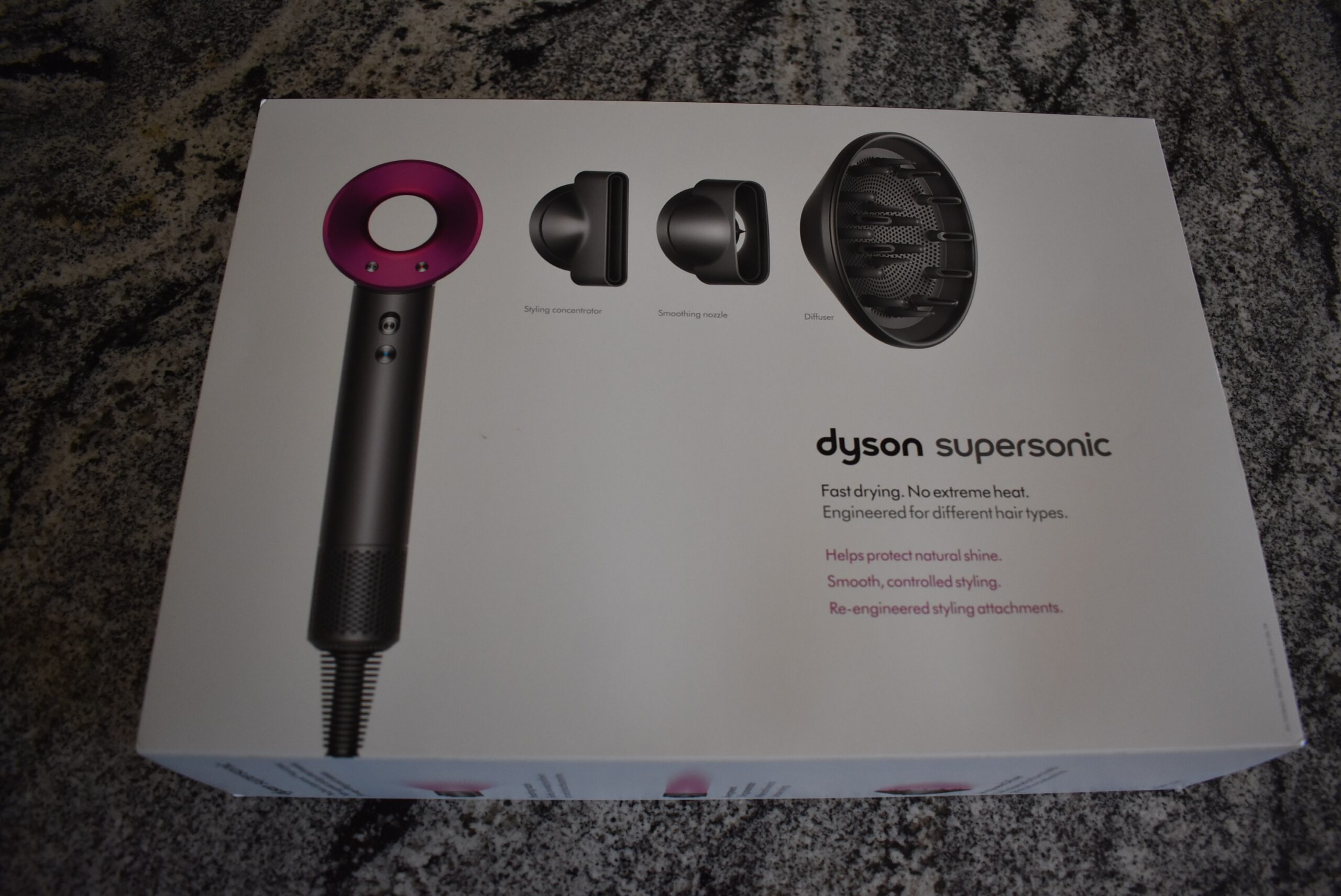 For a dyson hair dryer review, the front of the retail box sits on a grey counter
